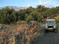 4wd car and Etna volcano on the background