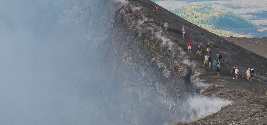 Visitors standing on the craters rim during an Etna summit craters excursion